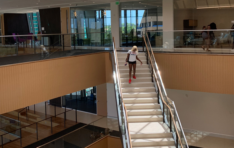 Daytona State College Student walking down terrazzo stairs